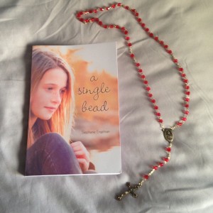 A Single Bead by Stephanie Engelman and my mom's St. Therese of Lisieux rosary